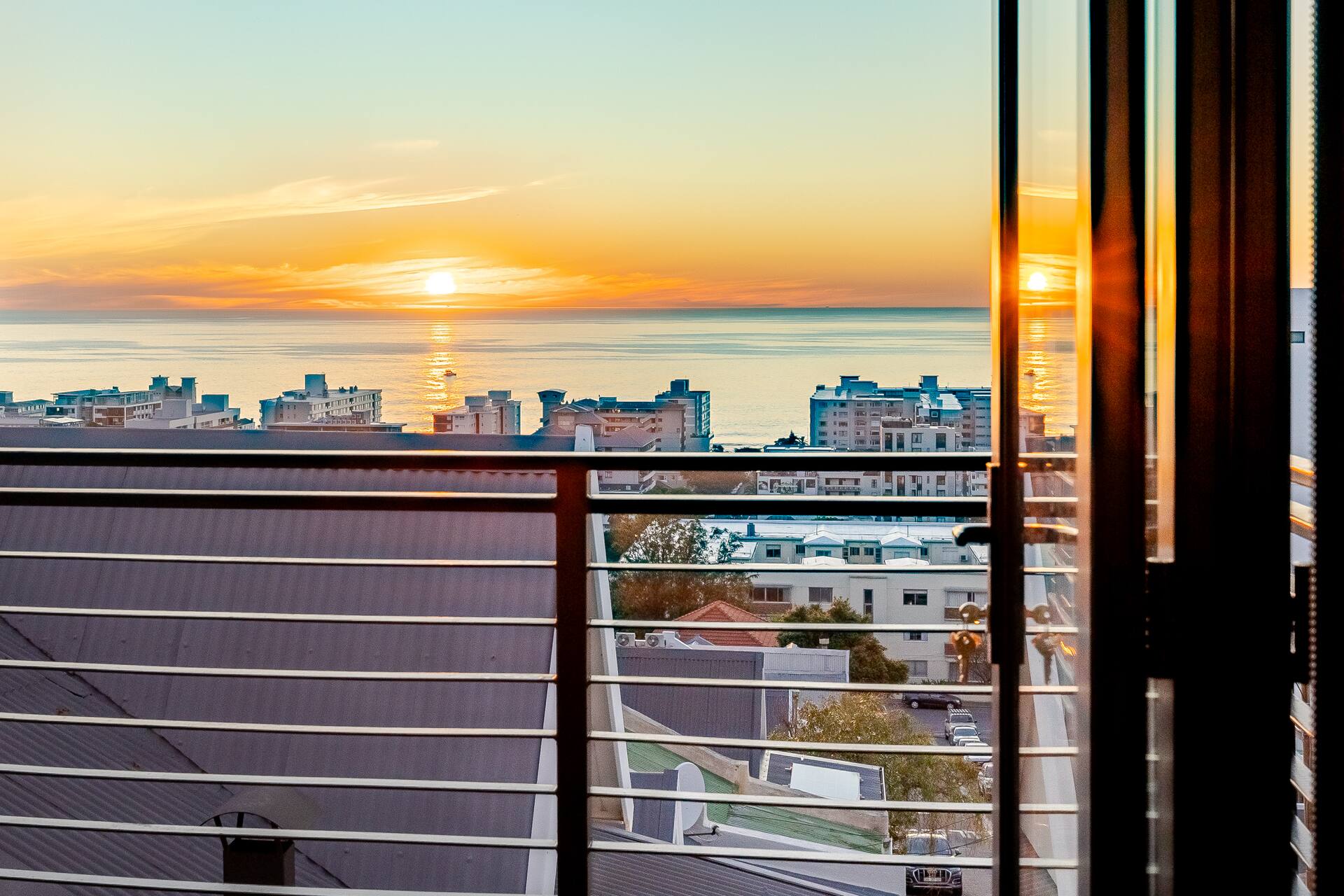 The Atlantic and the Sea Point skyline at sunset, seen from the balcony of The Firdale